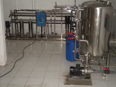 A stainless steel water treatment system with pumps and a pressure tank