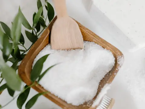 Coarse white salt in a wooden box with a wooden spoon
