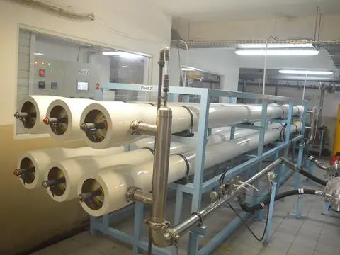 Rows of white reverse osmosis membrane housings in a bright treatment room