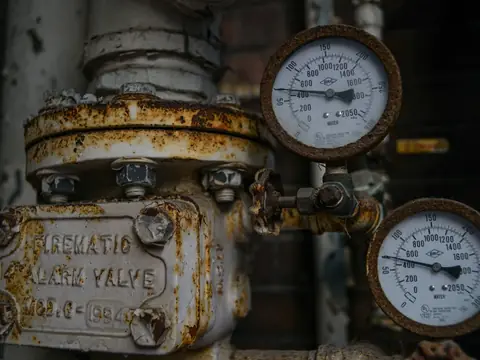 An old pressure valve with gauges on a water line