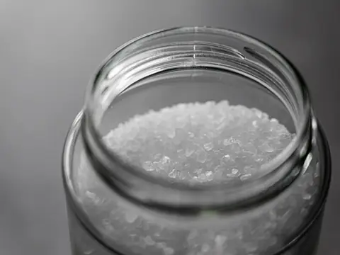 Salt crystals in an open glass jar